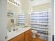 Bathroom with light wood cabinets, a bright shower curtain, and wood floors at 14626 N 132Nd Ave, Surprise, AZ 85379