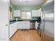 Well-lit kitchen with white cabinets, stainless steel appliances, and a sleek black countertop at 14626 N 132Nd Ave, Surprise, AZ 85379