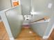 Staircase leading to the lower level with wooden steps and soft green walls at 14626 N 132Nd Ave, Surprise, AZ 85379