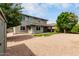 A two-story home with a low-maintenance backyard, an overhanging porch, and well-manicured landscaping at 14727 W Pasadena Ave, Litchfield Park, AZ 85340