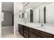 Bathroom featuring a double vanity with dark wood cabinets and an extra large mirror at 14727 W Pasadena Ave, Litchfield Park, AZ 85340