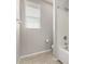 Bathroom featuring a combined shower and tub with bright natural light from the window at 14727 W Pasadena Ave, Litchfield Park, AZ 85340