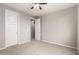 Empty bedroom with a ceiling fan and white doors leading to other rooms at 14727 W Pasadena Ave, Litchfield Park, AZ 85340