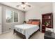 Cozy bedroom featuring a comfortable bed, ceiling fan, and natural light from the window at 14727 W Pasadena Ave, Litchfield Park, AZ 85340