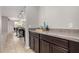 The butler's pantry features dark cabinets and granite countertops at 14727 W Pasadena Ave, Litchfield Park, AZ 85340