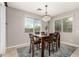 Bright dining room with modern chandelier, a six-chair dining set, and natural light at 14727 W Pasadena Ave, Litchfield Park, AZ 85340