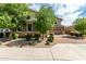 Charming home featuring a well-maintained yard with stone accents and a brick driveway at 14727 W Pasadena Ave, Litchfield Park, AZ 85340