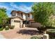 Beautiful home features a well-maintained yard with stone accents and brick driveway at 14727 W Pasadena Ave, Litchfield Park, AZ 85340