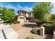 Beautiful home features a well-maintained yard with stone accents and brick driveway at 14727 W Pasadena Ave, Litchfield Park, AZ 85340