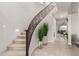 A gorgeous staircase and tile floors in the foyer are accentuated by greenery and natural light at 14727 W Pasadena Ave, Litchfield Park, AZ 85340