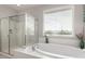 Main bathroom with soaking tub and glass enclosed shower at 14727 W Pasadena Ave, Litchfield Park, AZ 85340
