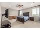 Main bedroom with carpet, fan and ensuite bathroom at 14727 W Pasadena Ave, Litchfield Park, AZ 85340