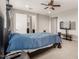 Main bedroom with carpet, fan and ensuite bathroom at 14727 W Pasadena Ave, Litchfield Park, AZ 85340