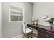 Small home office with a white desk chair, black desk and a window with blinds at 14727 W Pasadena Ave, Litchfield Park, AZ 85340
