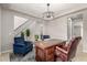 This is a home office with two arm chairs, rug, plants and decorative chandelier at 14727 W Pasadena Ave, Litchfield Park, AZ 85340