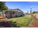 Spacious backyard showcasing a well-maintained lawn, patio with pool, and a secure cat enclosure at 1540 E Glencove St, Mesa, AZ 85203