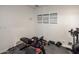 Basement gym area equipped with workout bench, weights, foam floor mats, and training posters on the wall at 1540 E Glencove St, Mesa, AZ 85203