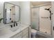 Bathroom featuring a white vanity with marble countertop, matte black faucet, and glass shower enclosure at 1540 E Glencove St, Mesa, AZ 85203