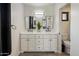 Bathroom featuring double sink vanity with marble countertop, matte black faucets, and decorative potted plant at 1540 E Glencove St, Mesa, AZ 85203