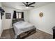 Bedroom featuring a ceiling fan, natural light, carpet flooring, and a rustic wood-paneled headboard at 1540 E Glencove St, Mesa, AZ 85203