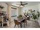 Cozy dining room with modern light fixture, neutral colors and wood-look tile flooring at 1540 E Glencove St, Mesa, AZ 85203
