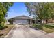 Inviting single-story home features a spacious driveway leading to a two-car garage and a well-kept lawn at 1540 E Glencove St, Mesa, AZ 85203