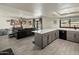 Spacious living room with tile floors, wet bar, and sliding door access to the pool area at 1540 E Glencove St, Mesa, AZ 85203