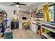 Well-lit office space with a fan, desk, storage, and creative decor at 1540 E Glencove St, Mesa, AZ 85203