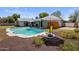 Backyard pool with surrounding patio furniture, landscaping, BBQ grill, and a covered patio area at 1540 E Glencove St, Mesa, AZ 85203