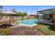 Backyard pool featuring clear blue water, a sun umbrella, and a lounge chair on a sunny day at 1540 E Glencove St, Mesa, AZ 85203