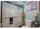 Cozy bathroom with glass shower doors, decorative floral accents, and neutral color palette at 16036 W Desert Bloom St, Goodyear, AZ 85338