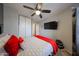Comfortable bedroom with a ceiling fan, mounted television, and closet at 16036 W Desert Bloom St, Goodyear, AZ 85338