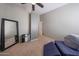 Bedroom with a mirror and a ceiling fan at 16036 W Desert Bloom St, Goodyear, AZ 85338