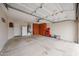 Spacious garage featuring ample storage cabinets, water heater, and room for parking and projects at 16036 W Desert Bloom St, Goodyear, AZ 85338