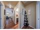 Hallway leading to living room and bathroom; wall decor on display at 16036 W Desert Bloom St, Goodyear, AZ 85338