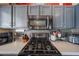 Up-close view of the stainless steel stove top and microwave in the kitchen at 16036 W Desert Bloom St, Goodyear, AZ 85338