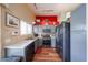 Bright kitchen with stainless steel appliances, gray cabinetry and wood flooring at 16036 W Desert Bloom St, Goodyear, AZ 85338
