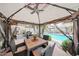 Covered outdoor dining area offering seating for four, views of the pool, and a relaxing atmosphere at 16036 W Desert Bloom St, Goodyear, AZ 85338