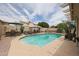 Sparkling pool with lush landscaping and a built-in outdoor kitchen area, perfect for summer gatherings at 16036 W Desert Bloom St, Goodyear, AZ 85338
