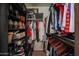 Organized walk-in closet with clothing racks and shelving for shoe storage at 16036 W Desert Bloom St, Goodyear, AZ 85338