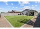 Large backyard featuring low-maintenance artificial turf, and a covered patio perfect for outdoor living at 17461 W Molly Ln, Surprise, AZ 85387