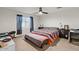 Comfortable bedroom with carpet, ceiling fan, and a window with coverings at 17461 W Molly Ln, Surprise, AZ 85387