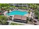 Community pool surrounded by lush landscaping, lounge chairs, and shaded areas for residents to enjoy at 17461 W Molly Ln, Surprise, AZ 85387