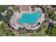 Aerial view of a large community pool with surrounding lounge areas and tropical landscaping at 17461 W Molly Ln, Surprise, AZ 85387