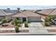 Charming single-story home featuring a well-manicured front yard, neutral paint, and a two-car garage at 17461 W Molly Ln, Surprise, AZ 85387
