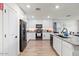Bright kitchen featuring granite counters, modern appliances and an island with barstool seating at 17461 W Molly Ln, Surprise, AZ 85387