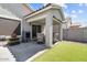 A covered patio area with outdoor seating and a well-maintained artificial grass lawn at 17461 W Molly Ln, Surprise, AZ 85387