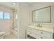 Clean bathroom with a white vanity, marble countertop, and a glass-enclosed shower at 1930 E Missouri Ave, Phoenix, AZ 85016