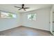 Simple bedroom with neutral colors, sleek flooring, and plenty of natural light from two windows at 1930 E Missouri Ave, Phoenix, AZ 85016