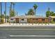 Charming single-story home featuring a brick facade, yellow front door, and desert landscaping at 1930 E Missouri Ave, Phoenix, AZ 85016